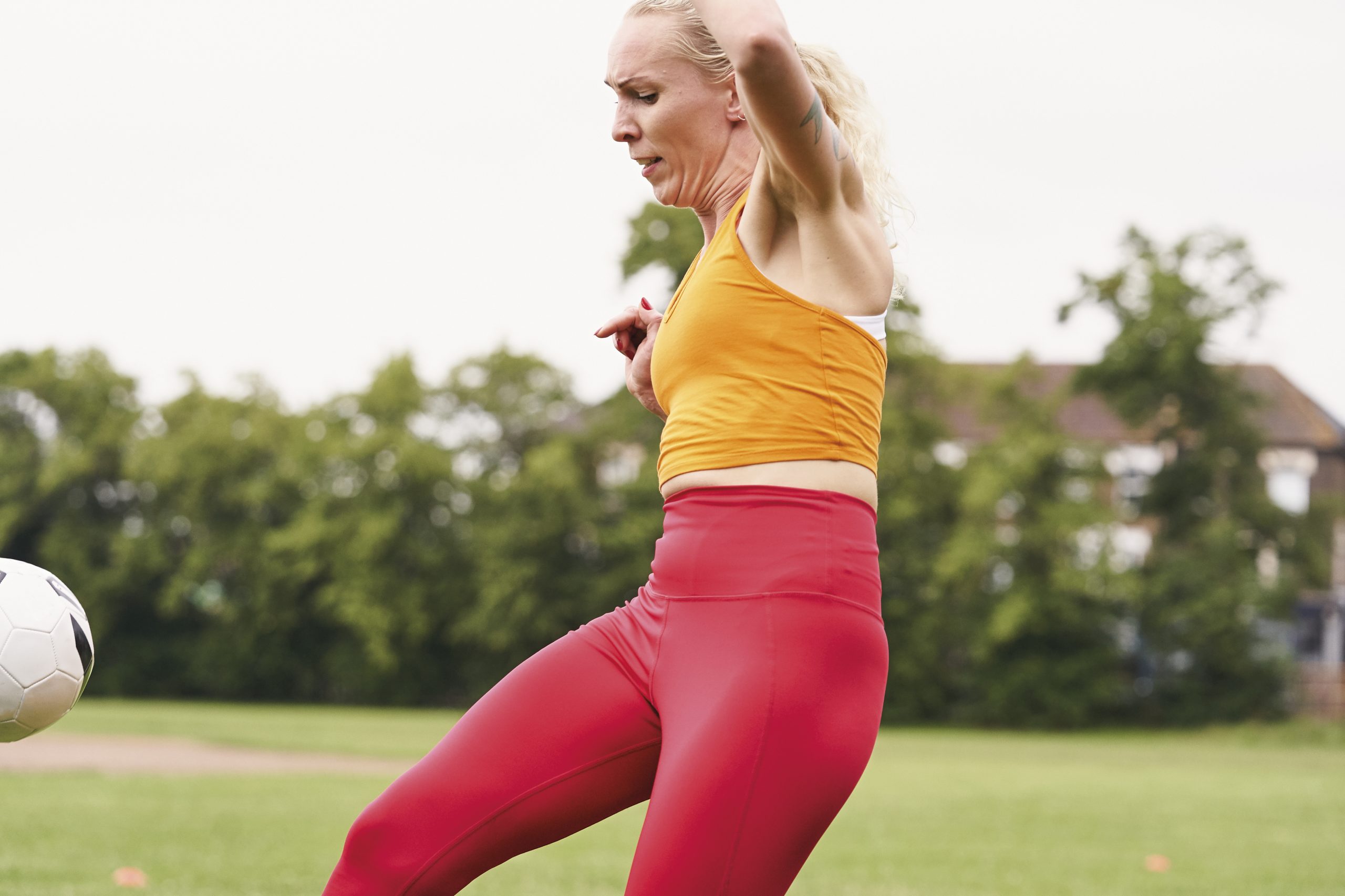 A white woman aged 45-50 playing football