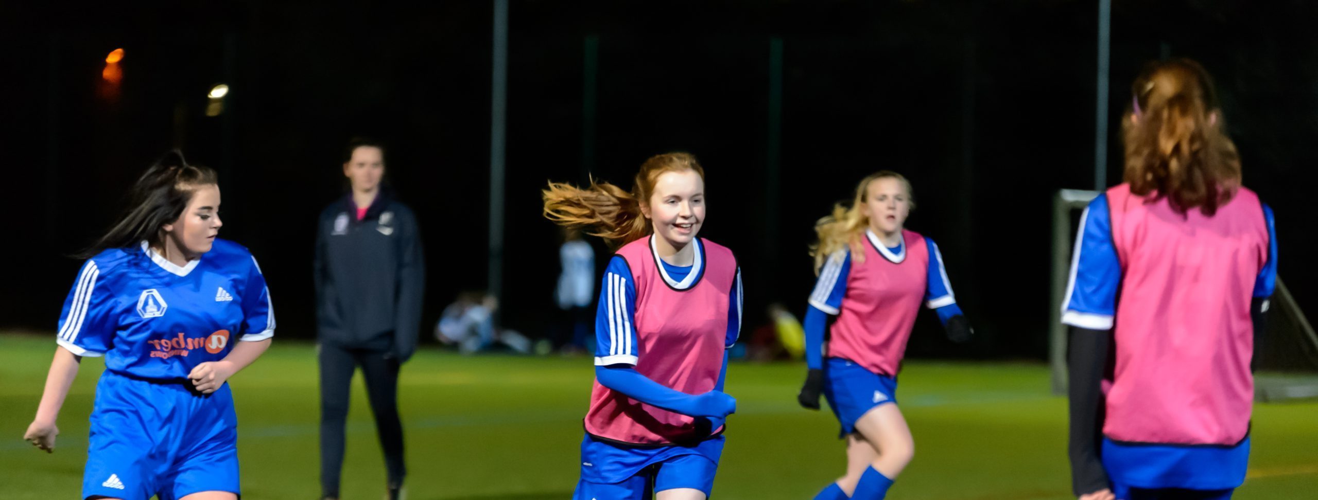 A group of young women aged 20-25 playing football