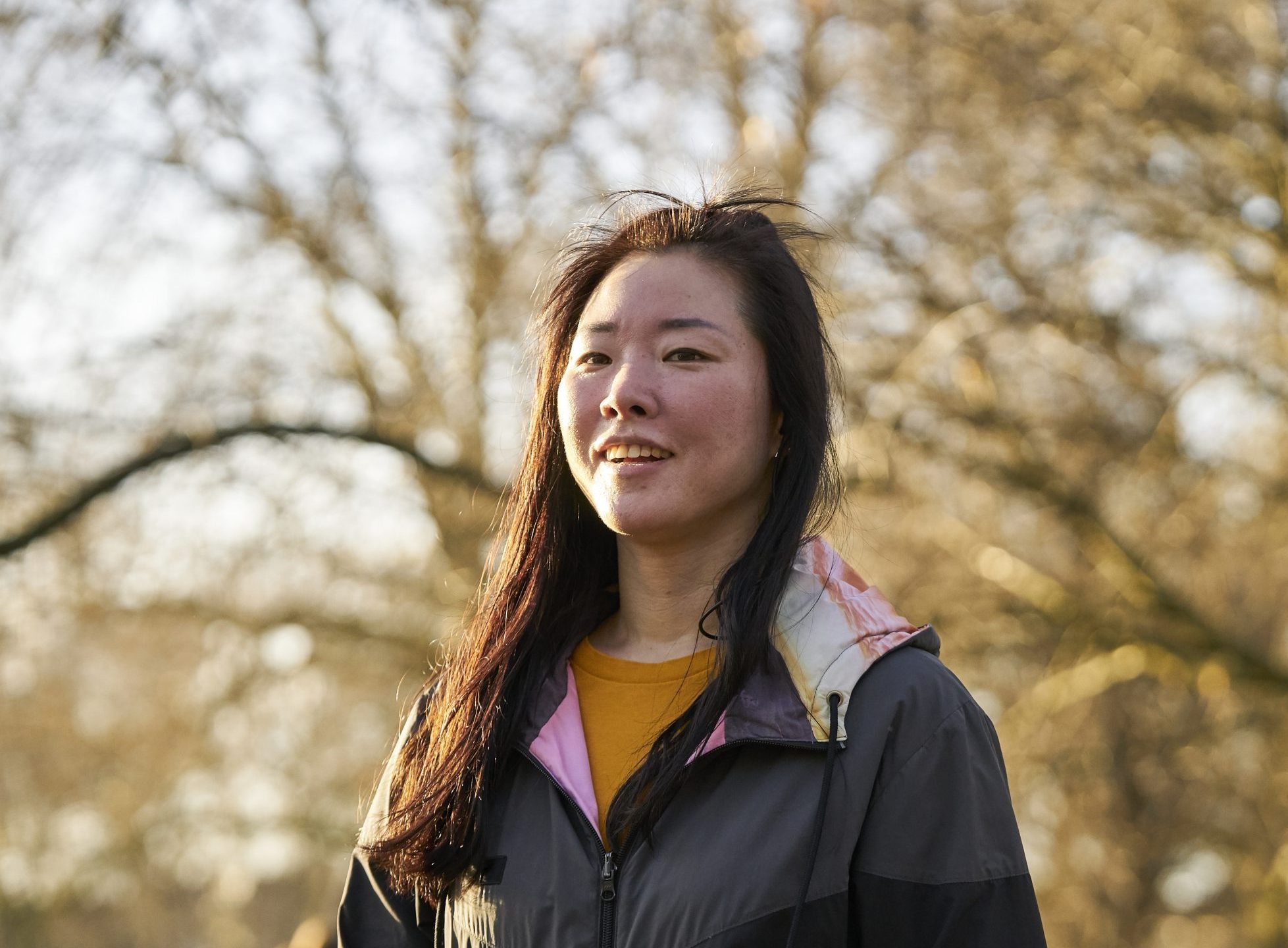 East Asian woman aged 25-30 with a flushed face after a run