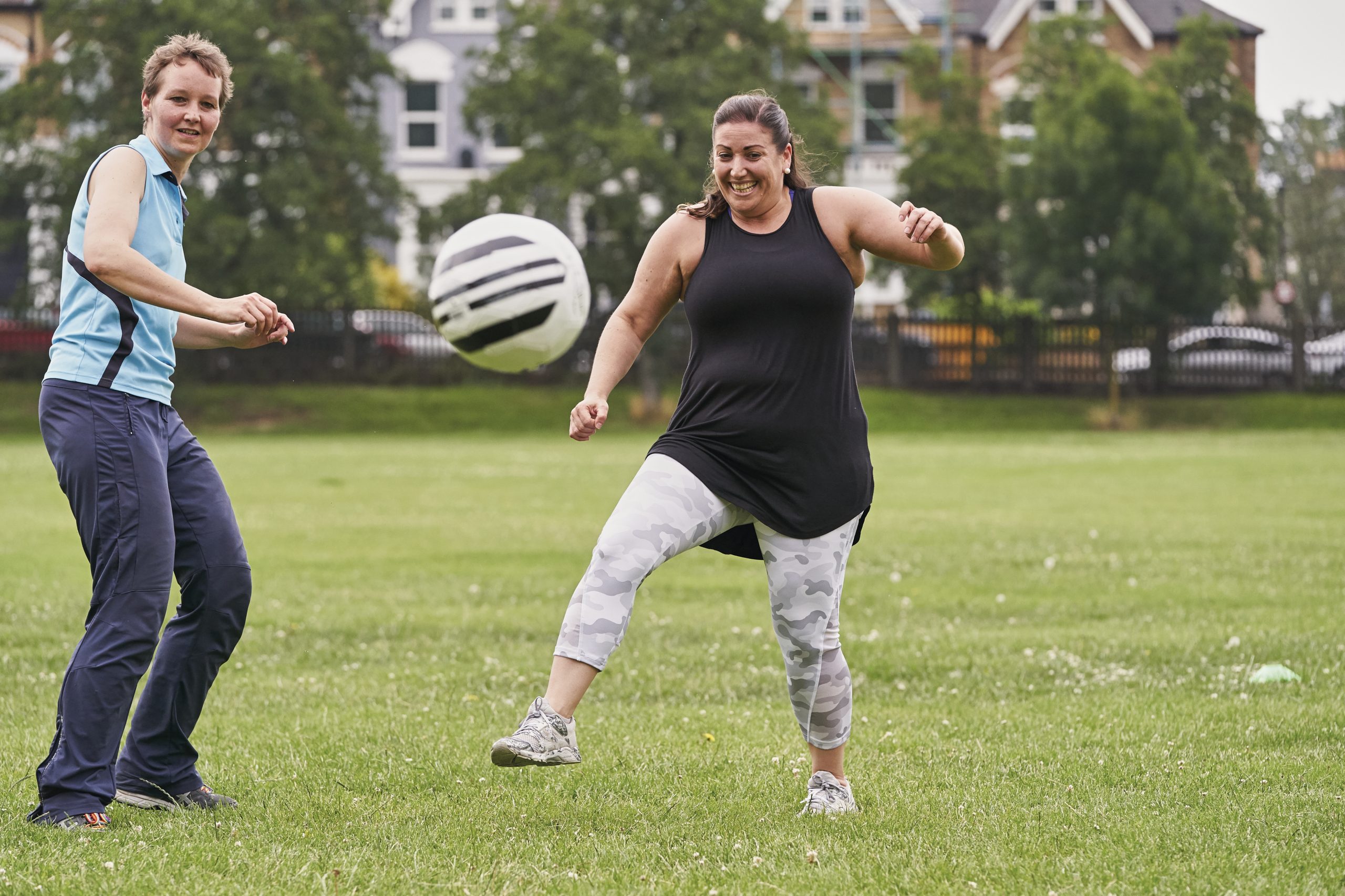 Two white women aged 40-50 playing football