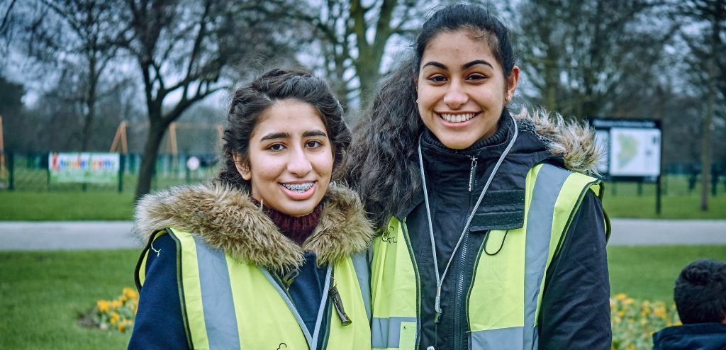 Two female Parkrun volunteers with darker complexions