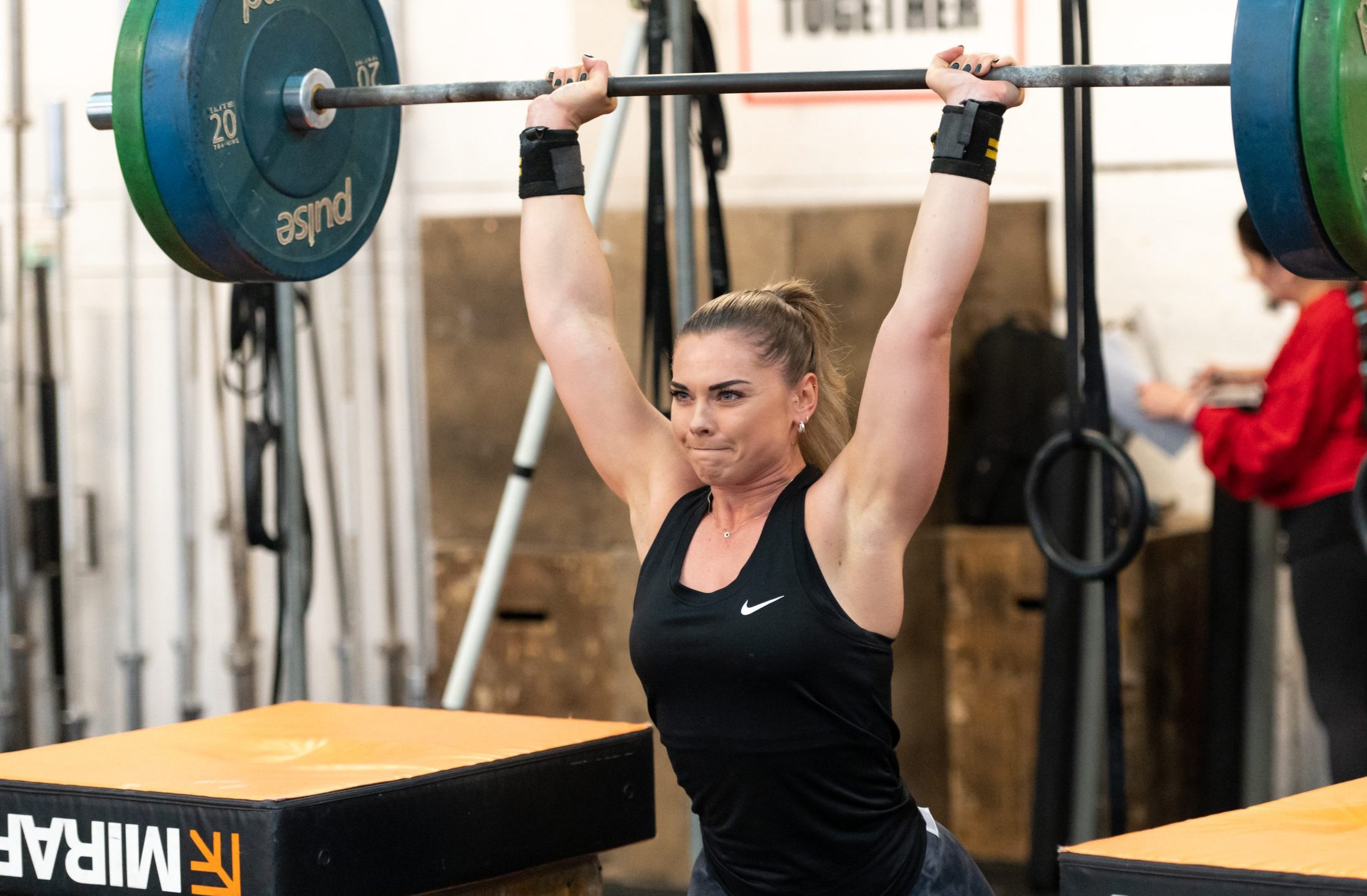 White woman aged 25-35 lifting a heavy weight
