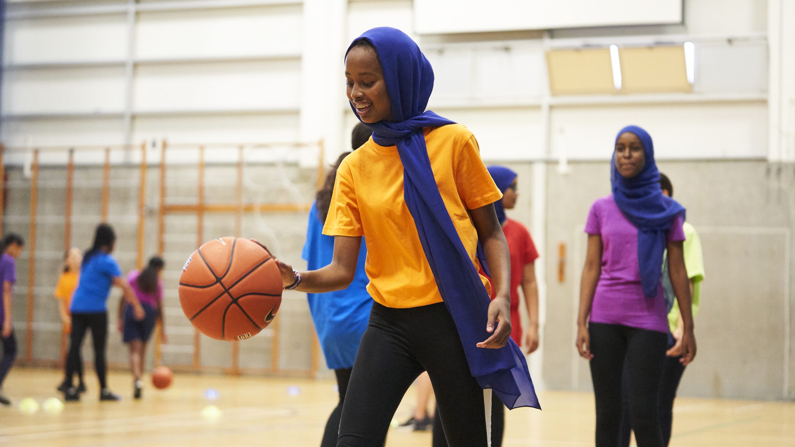 Muslim teenager playing basketball
