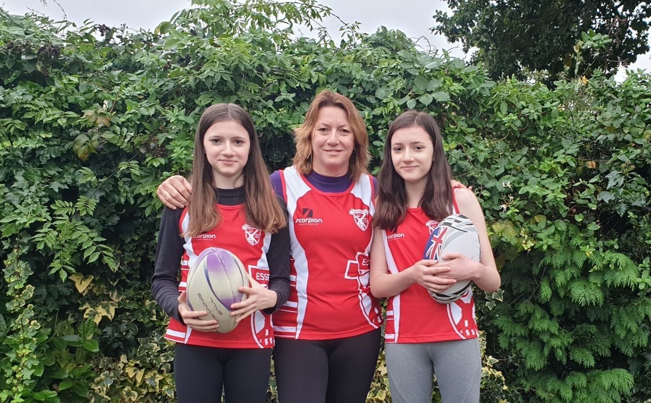 Angela and her two daughters in their rugby kit