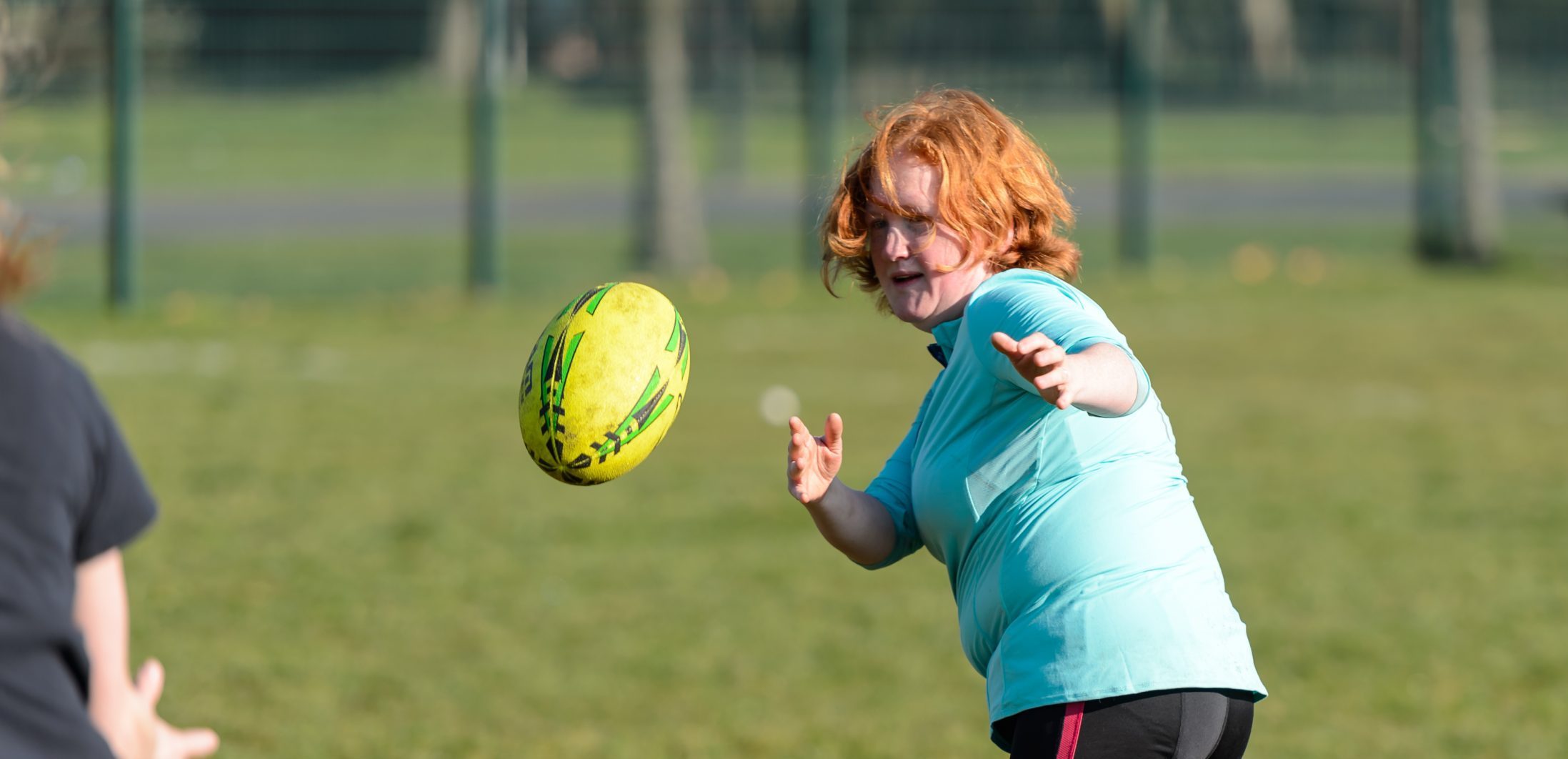 Red haired woman aged 35-45 playing rugby