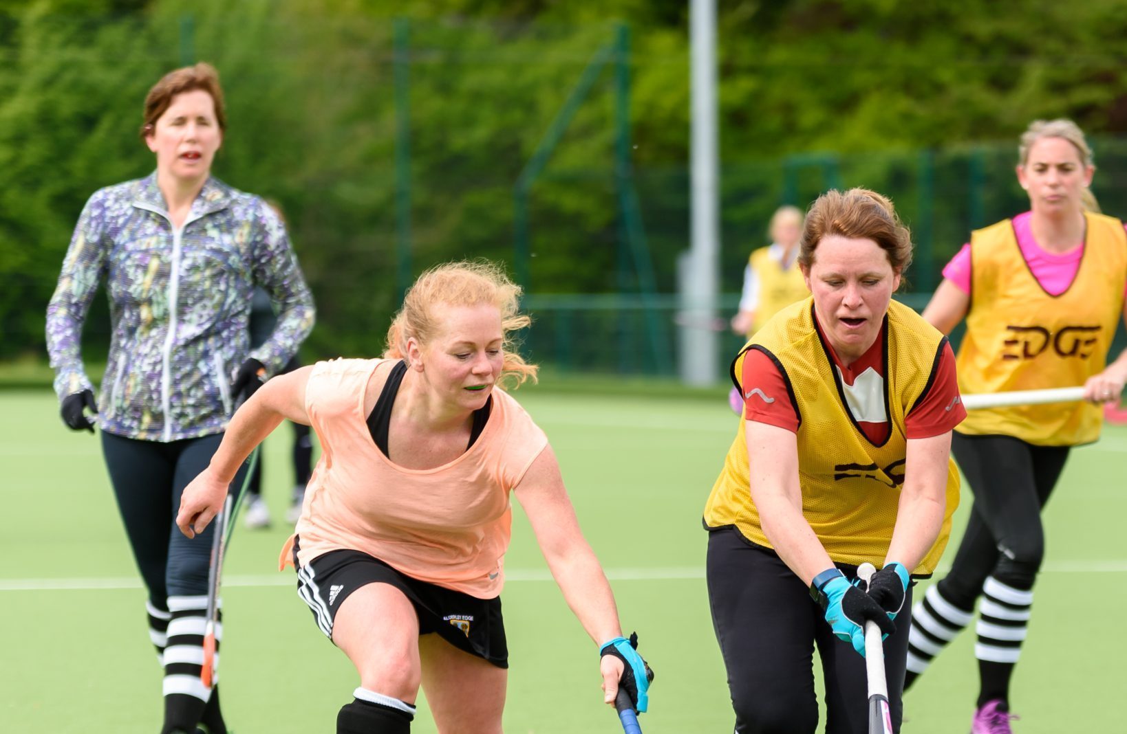 A group of women aged 40-50 playing hockey