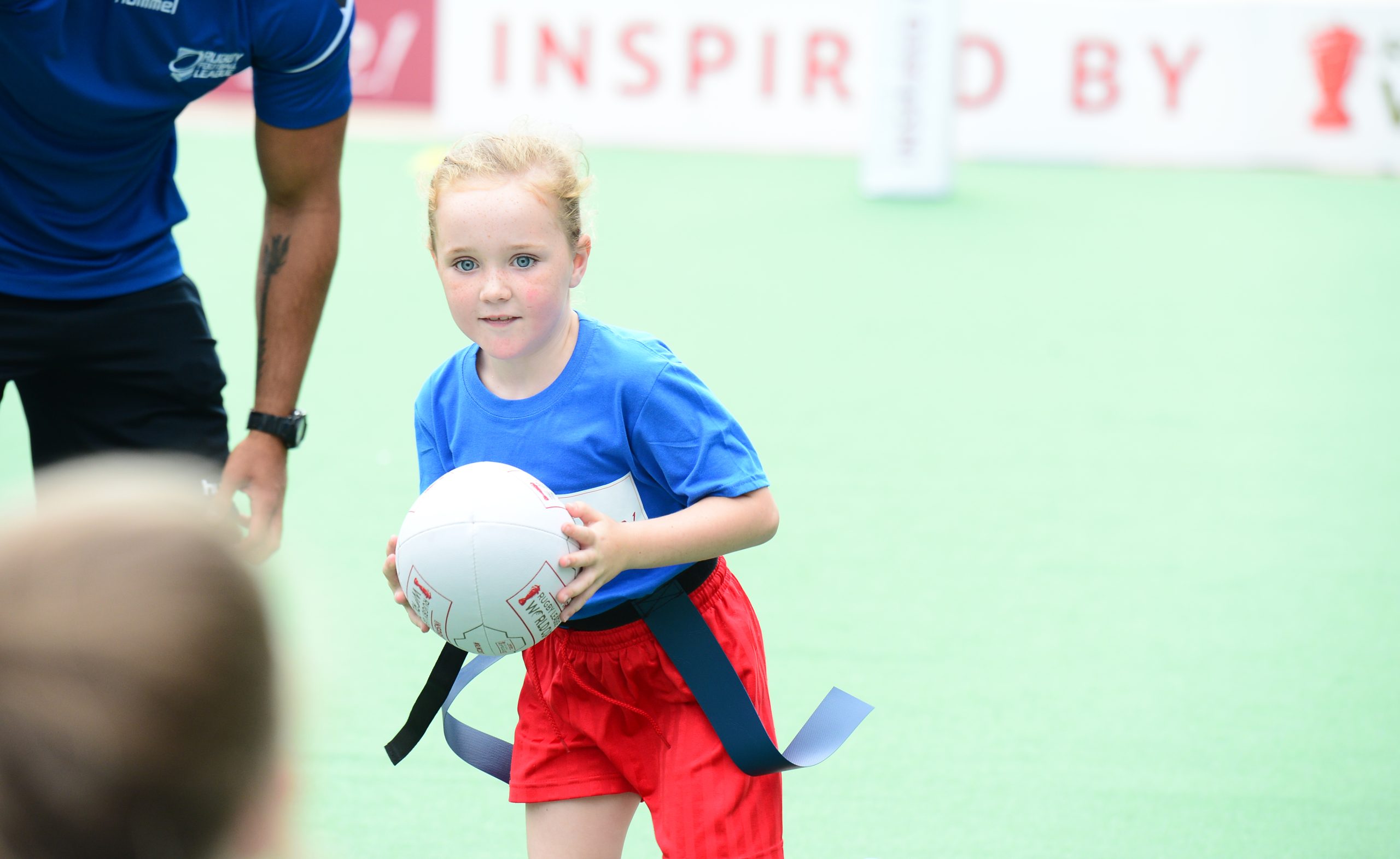 Young girl playing rugby