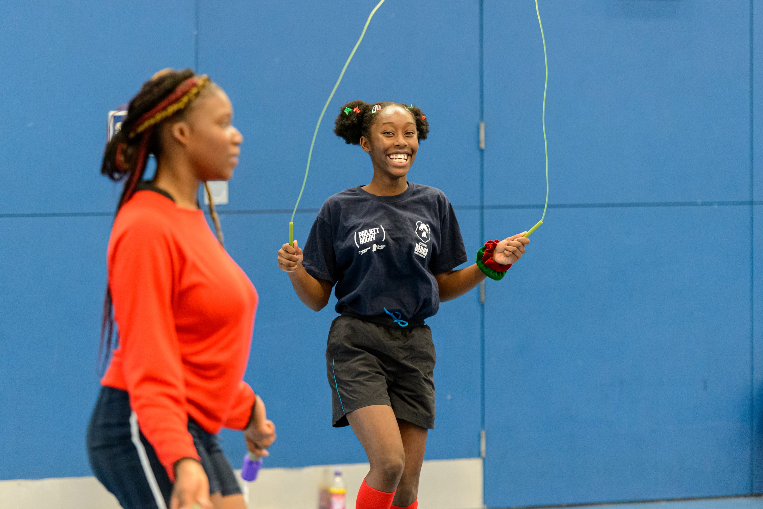Young black woman aged 13-15 playing with a skipping rope