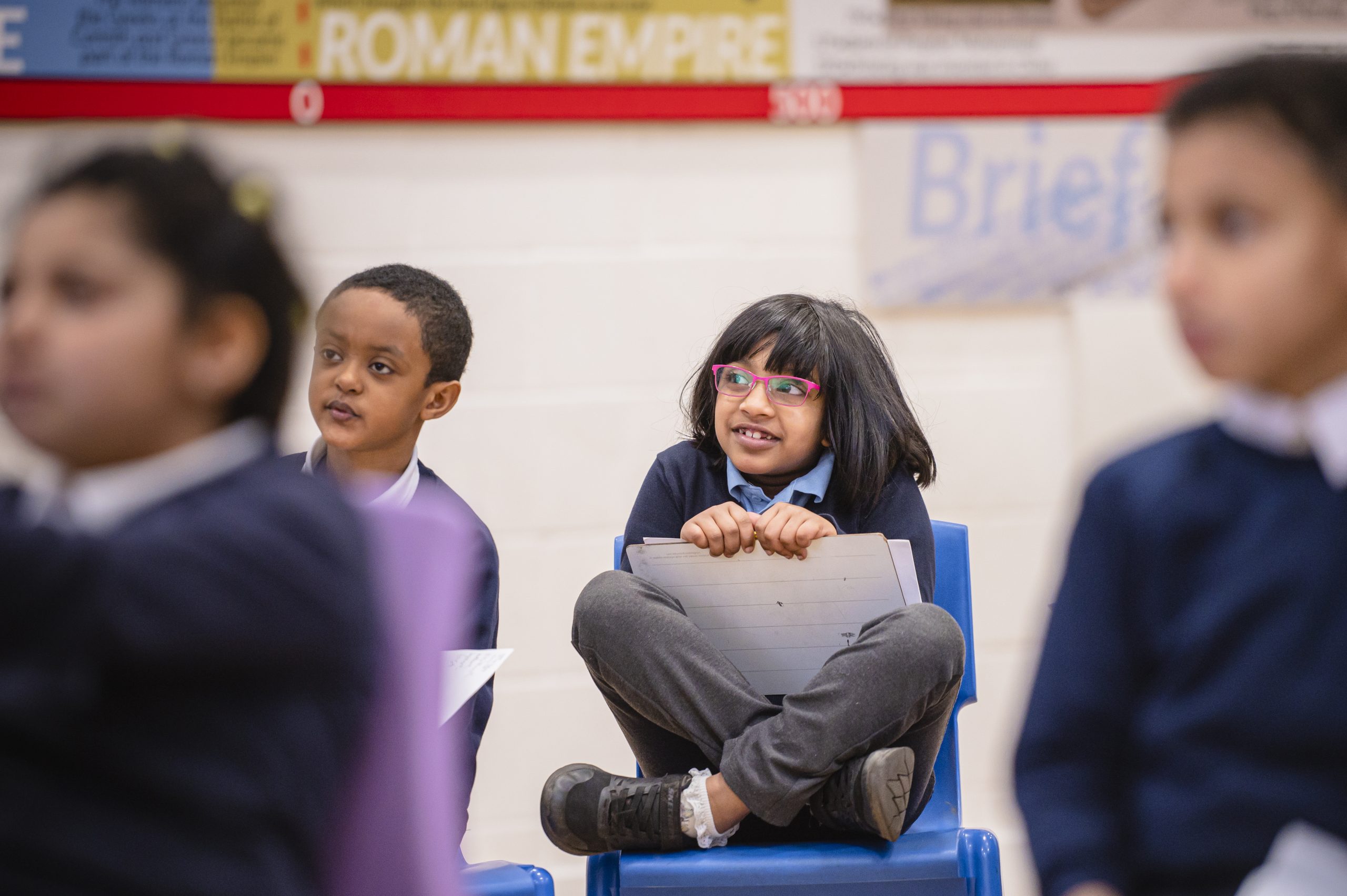 A young South Asian girl sat in primary school