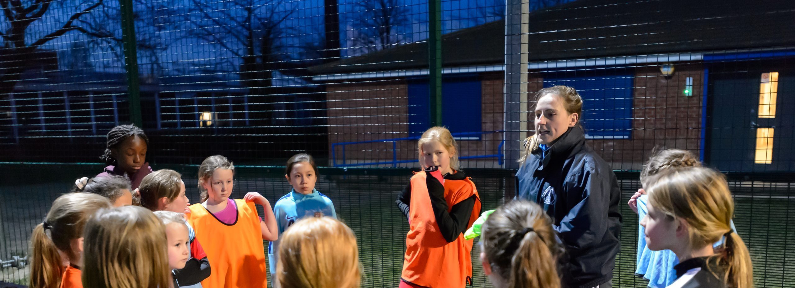 Young girls gathered in a circle after football training