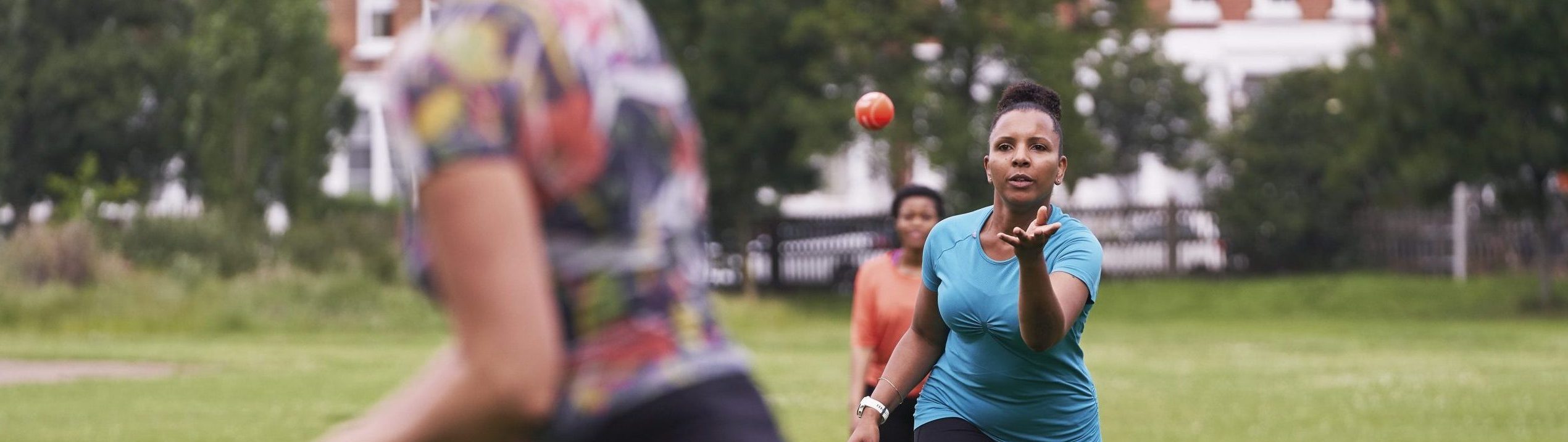 A black woman aged 40-45 throwing a ball
