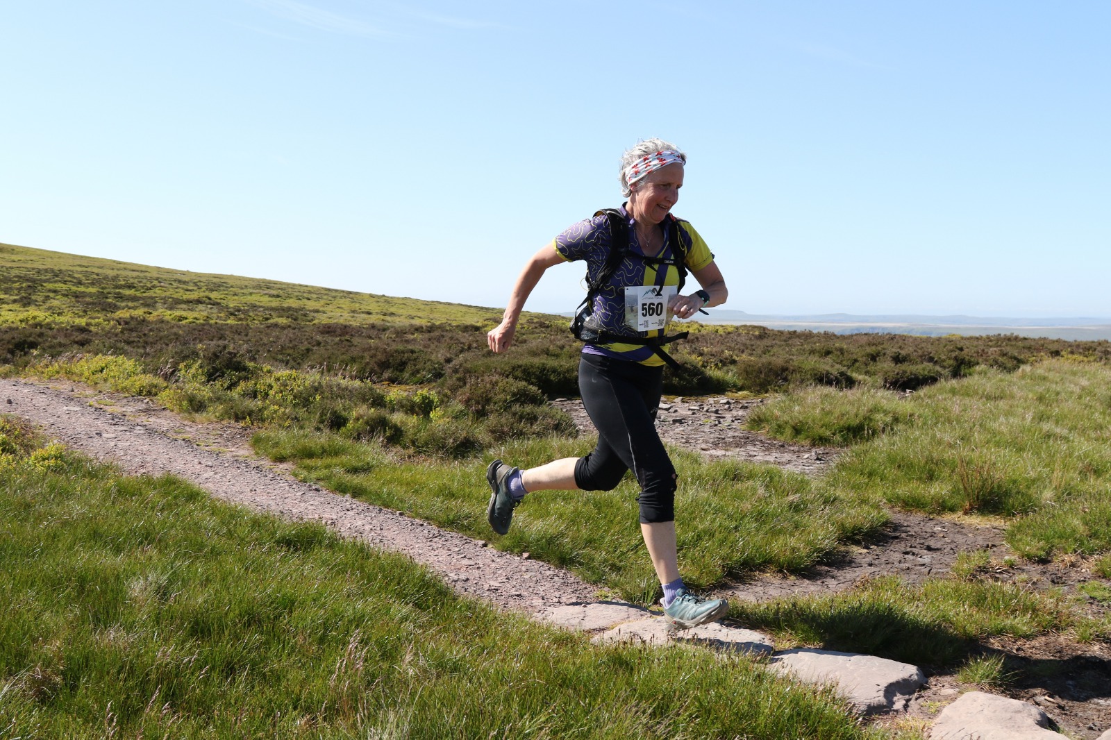 Woman aged 50-60 with grey hair running a half marathon