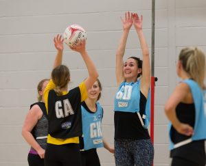 A group of high school girls playing netball