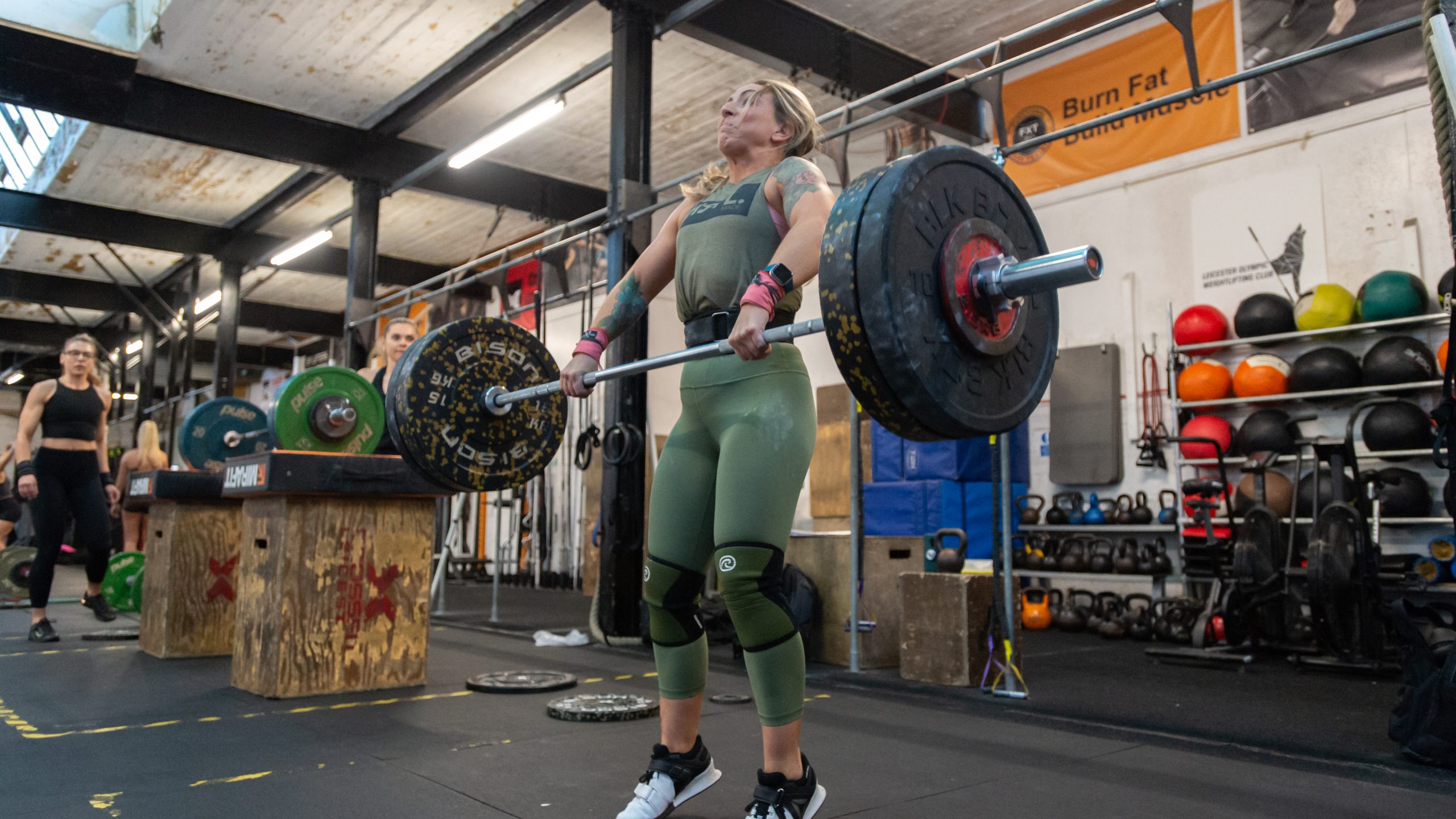 A white woman weightlifting