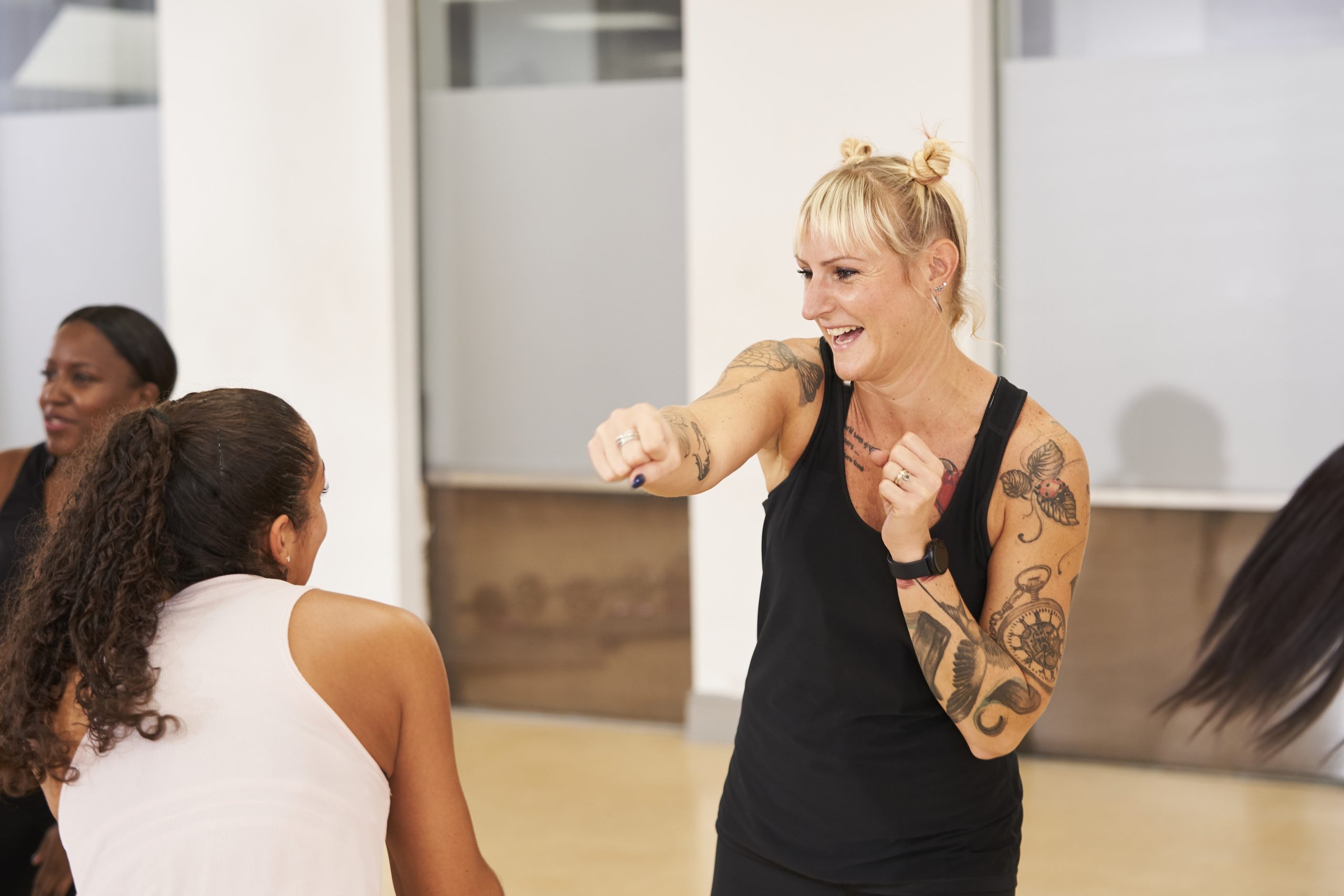 A white woman with tattoos boxing