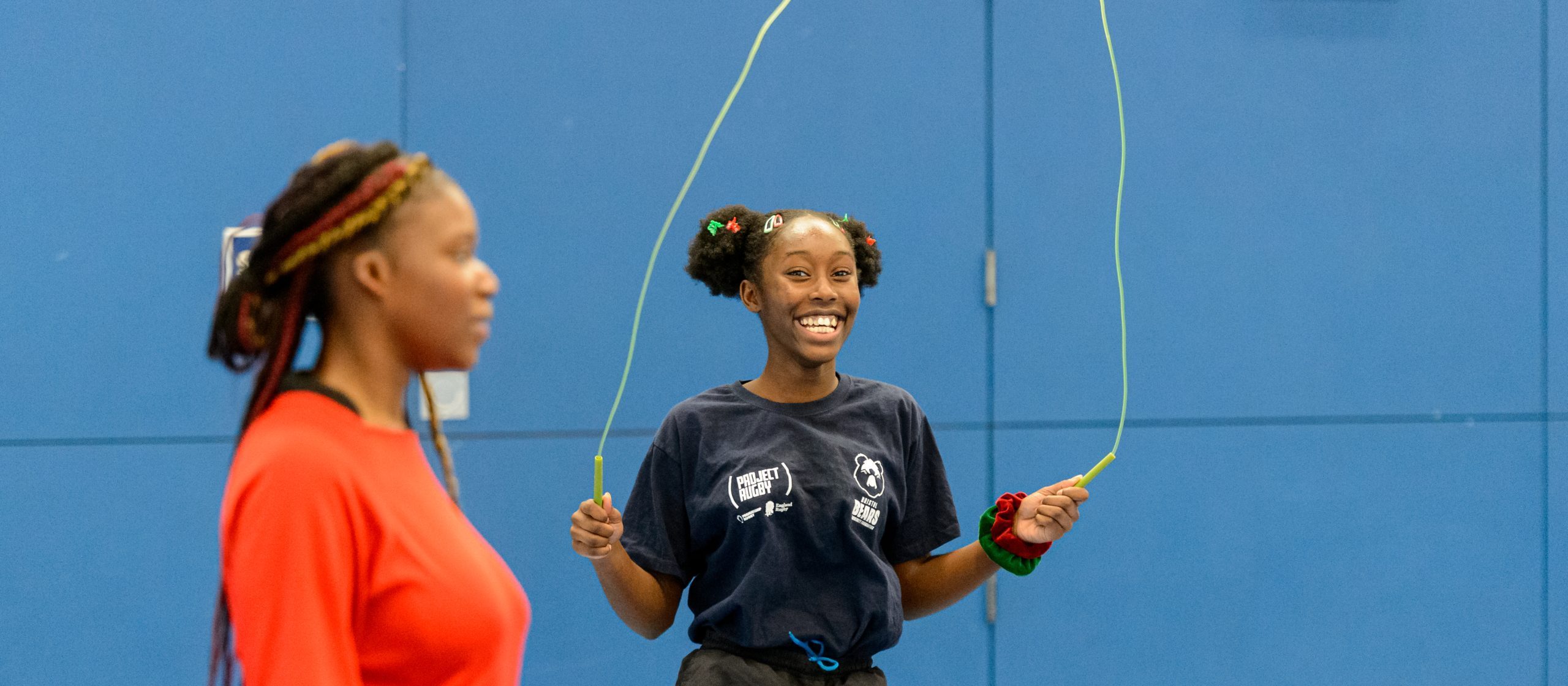 A young black teenager skipping rope