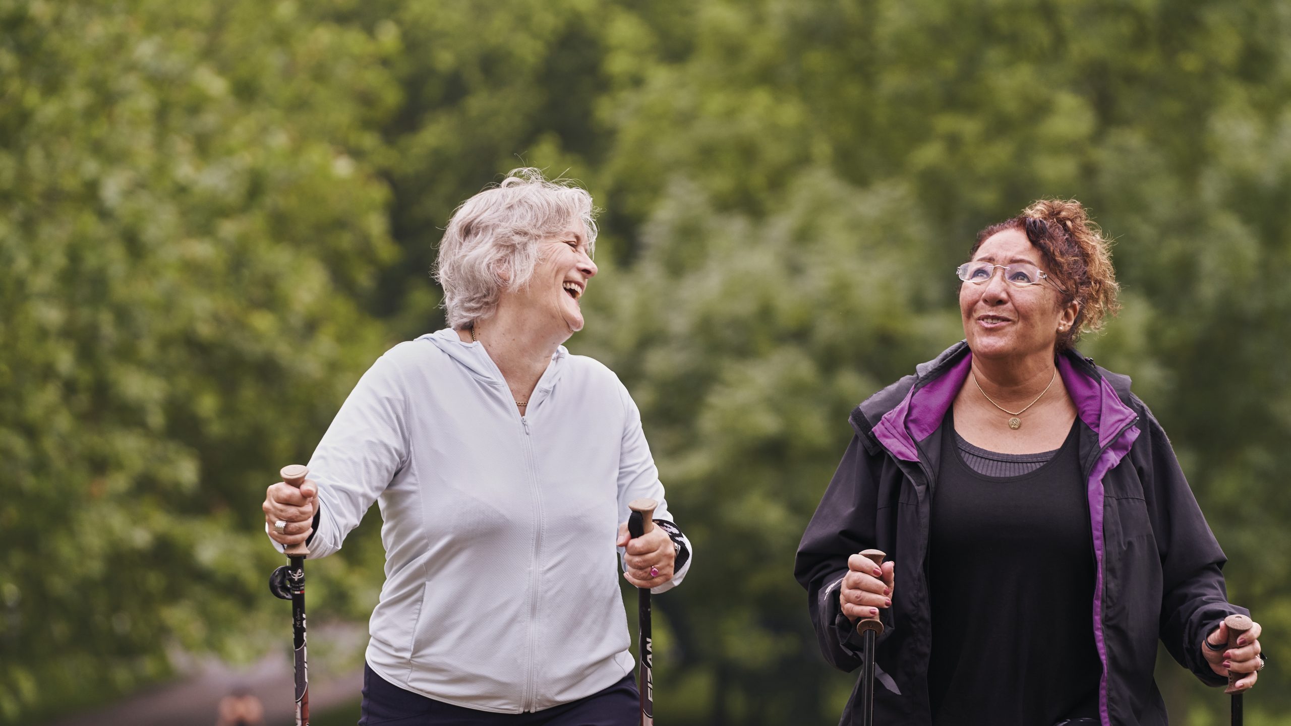 Two women aged 55-70 walking in the park