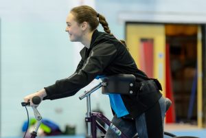 Young disabled woman using a mobility aid to play sport