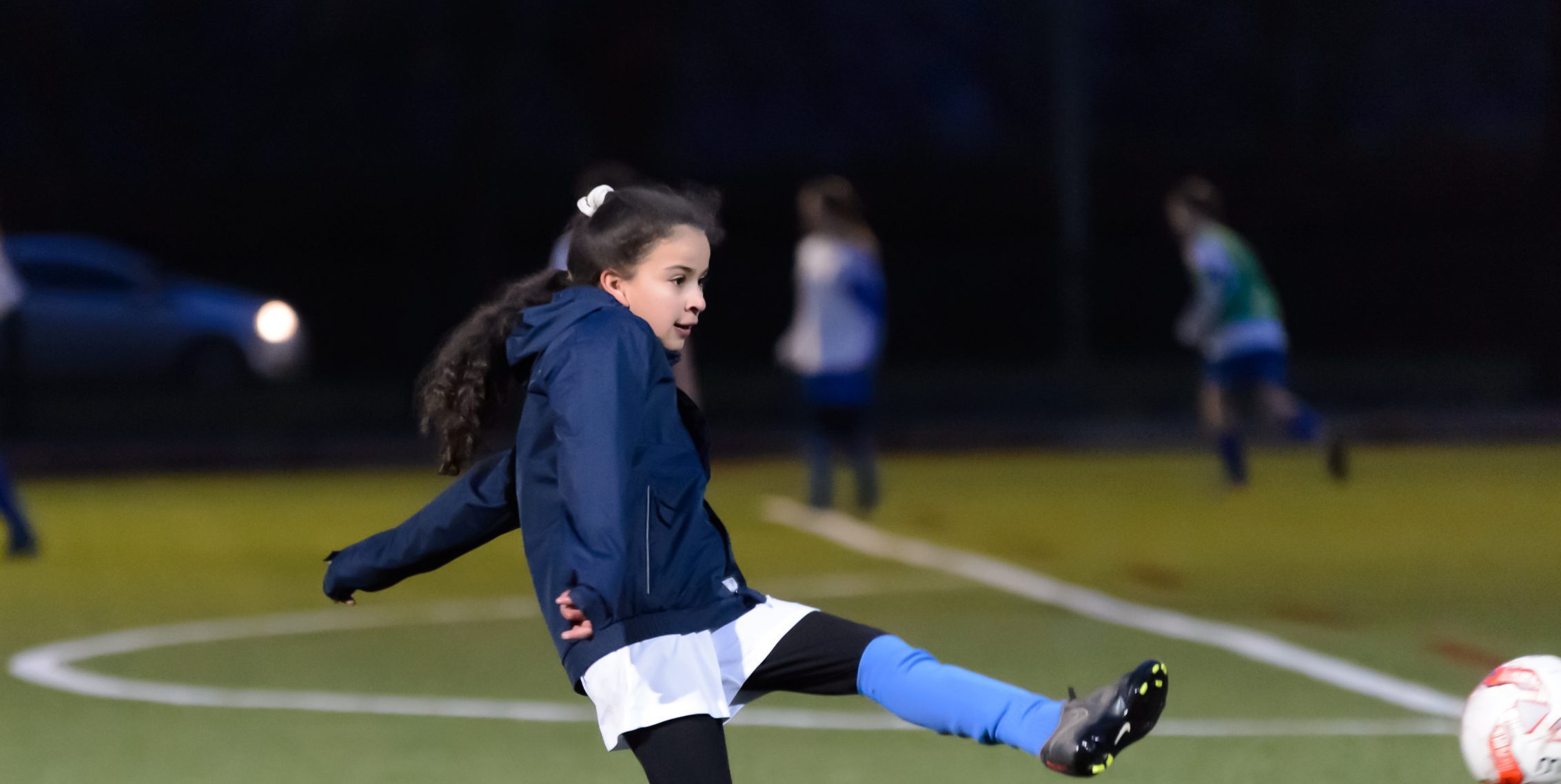 Young girl playing football