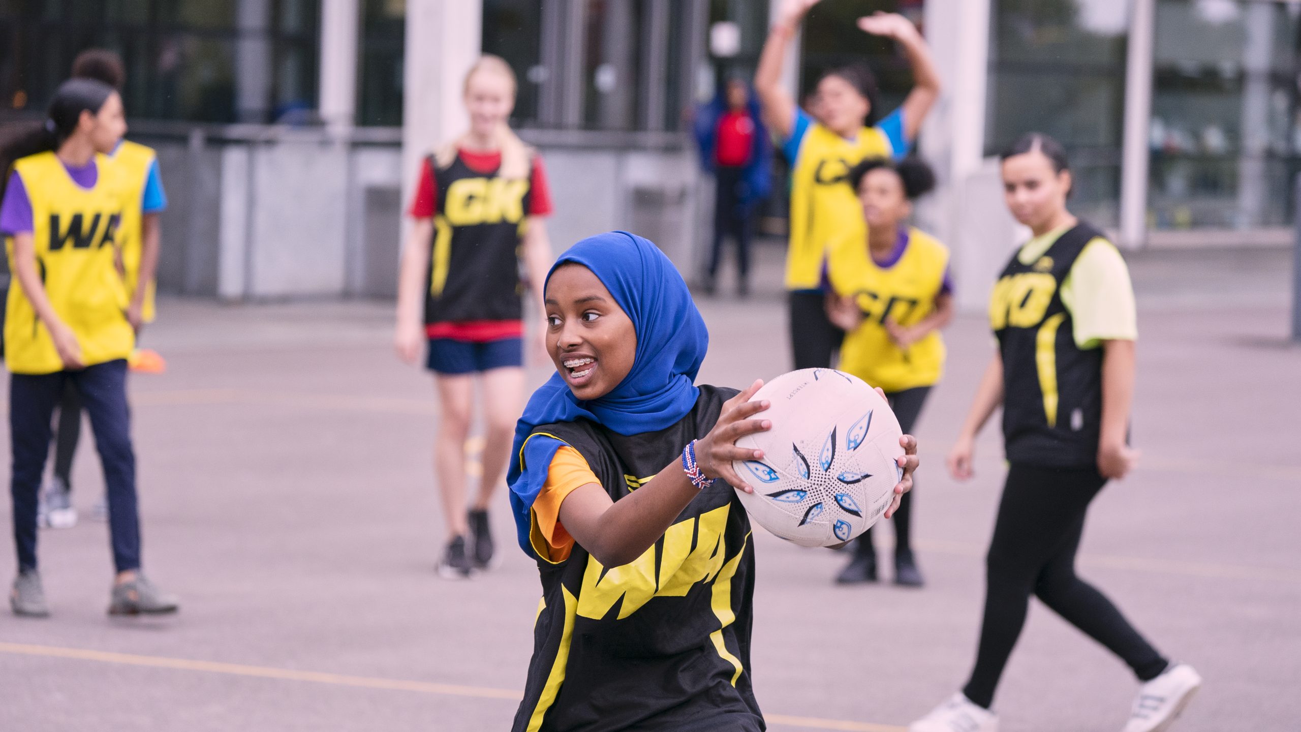 A young Muslim woman playing netball