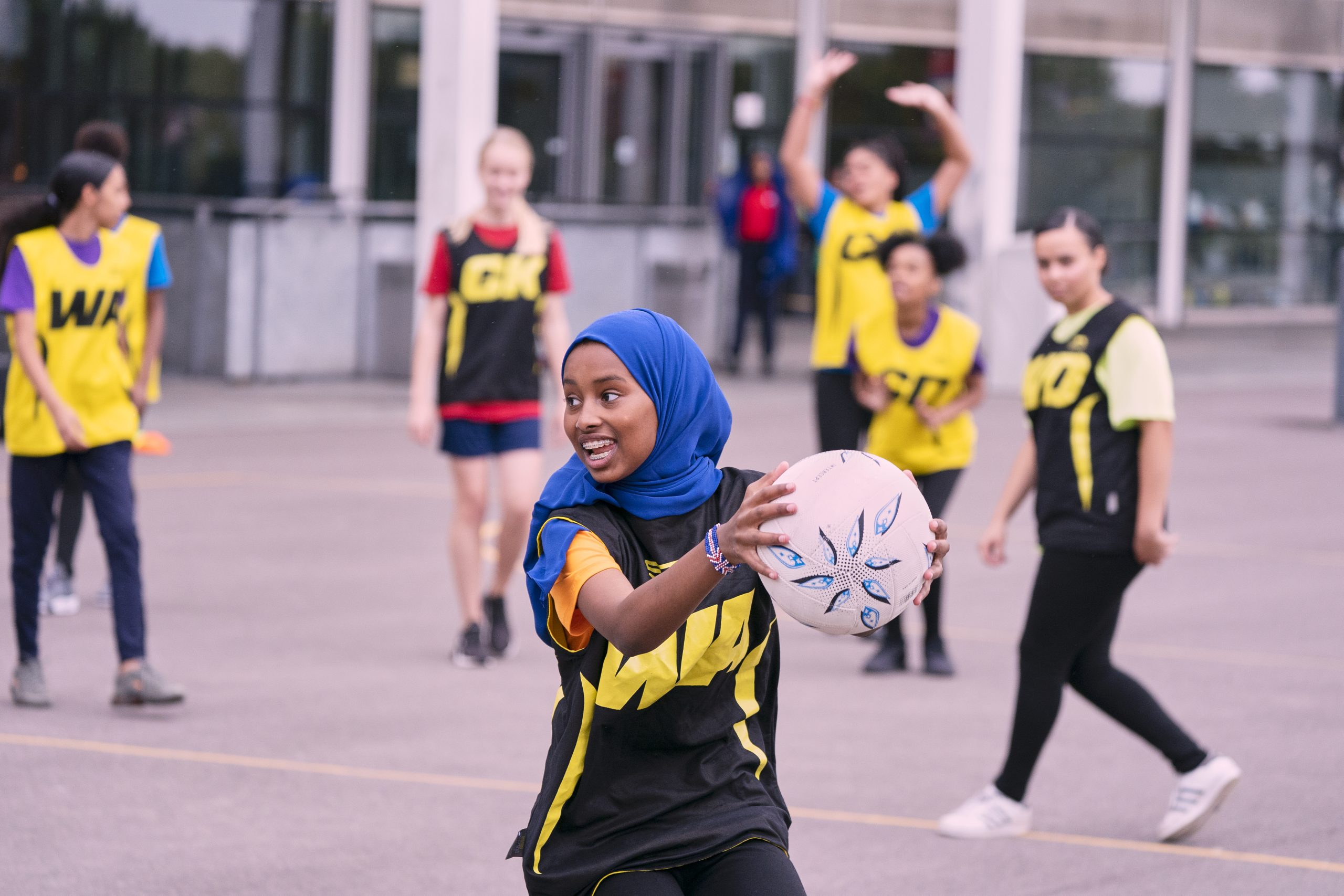 A young Muslim woman playing netball