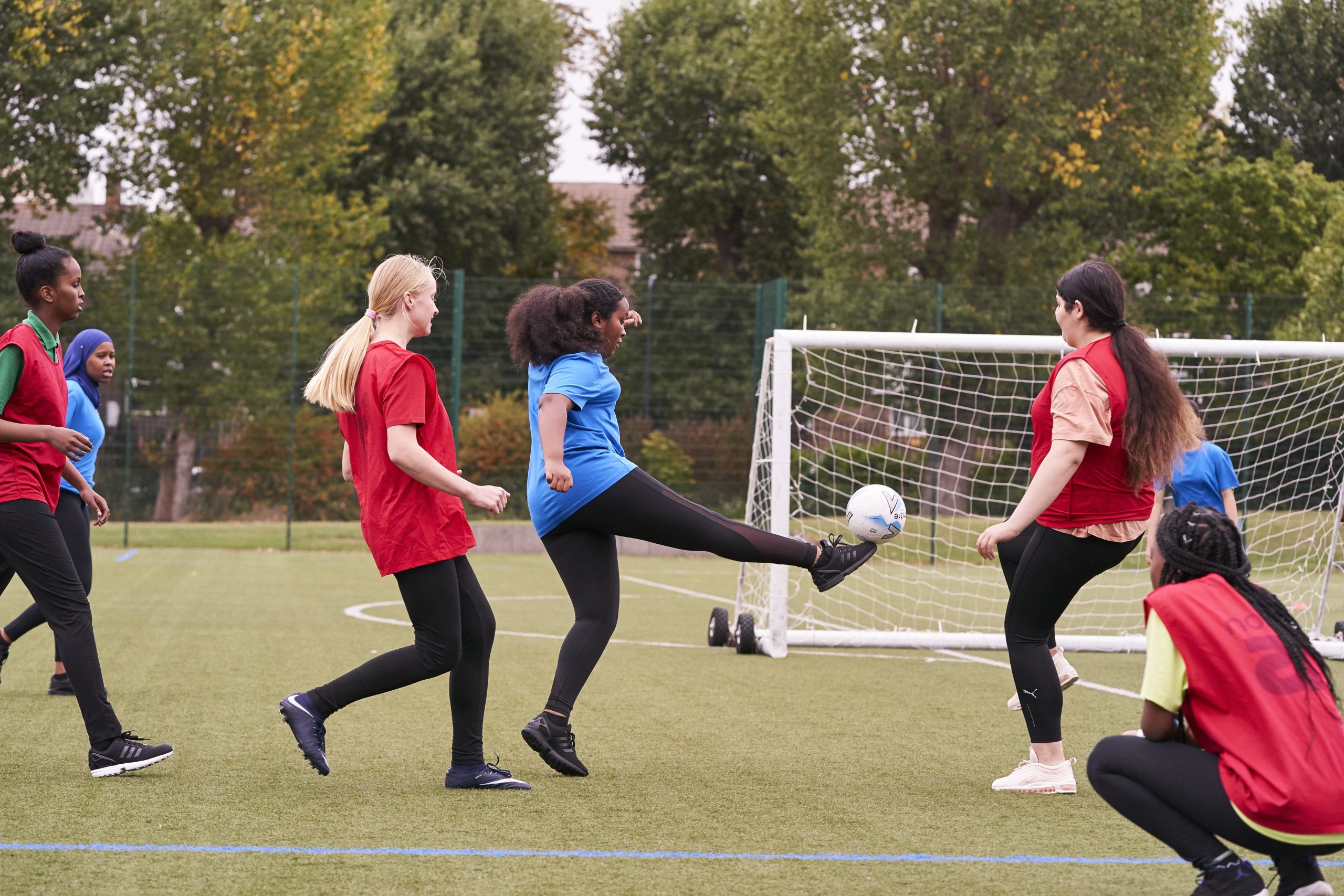 A group of girls playing football at school