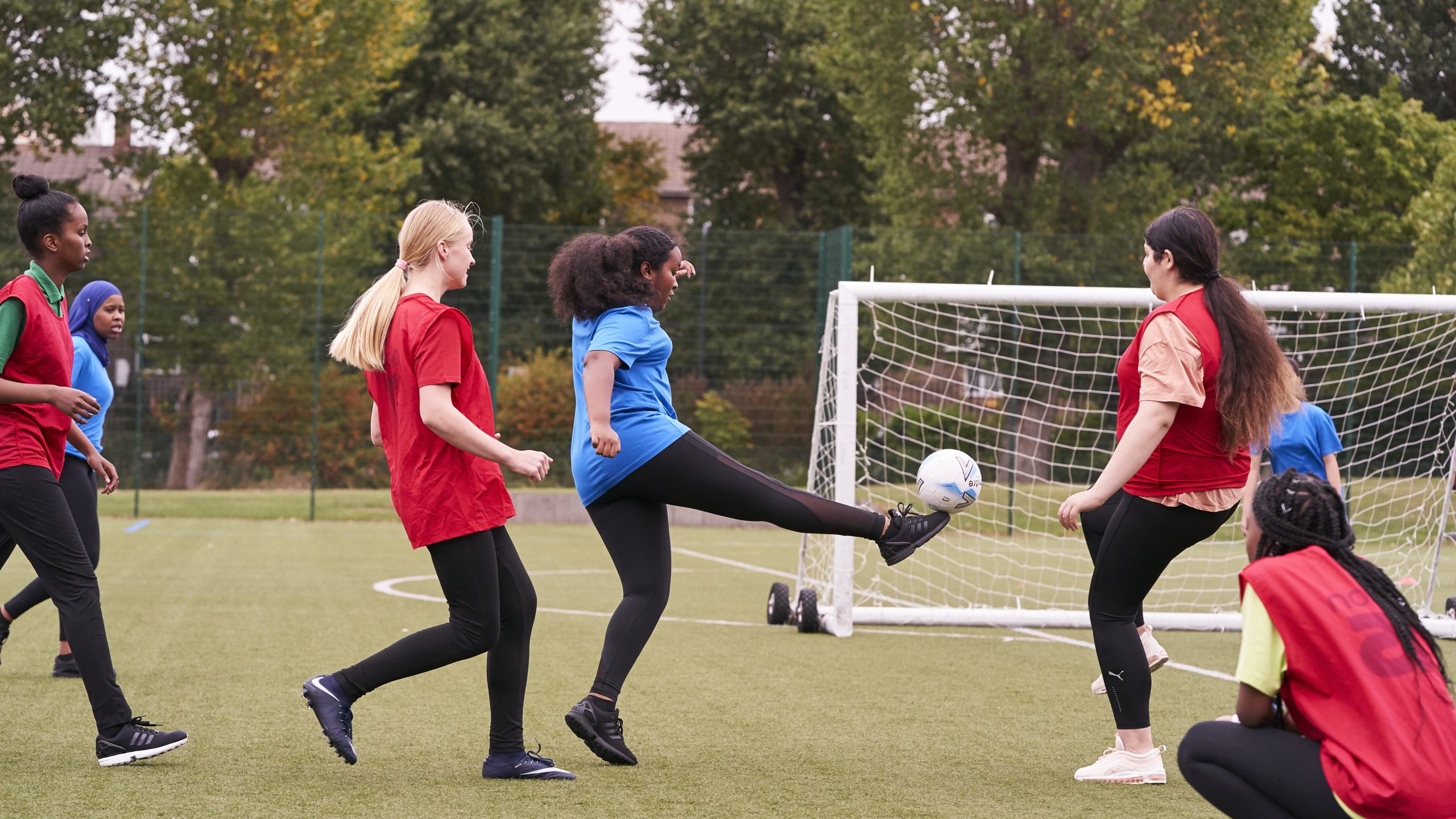 A group of teenage girls playing football