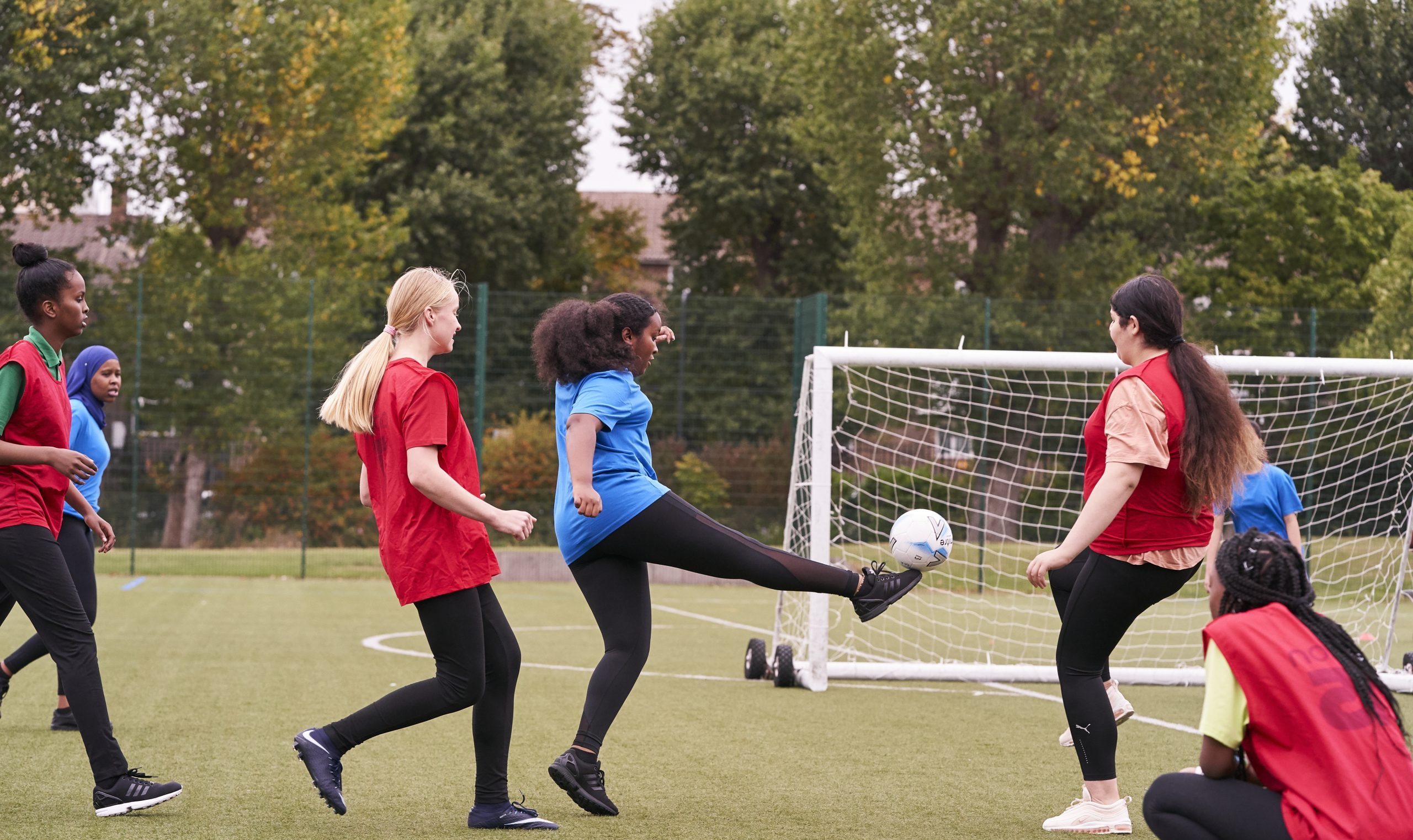 Teenage girls playing football