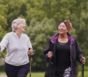 Two older women walking and chatting