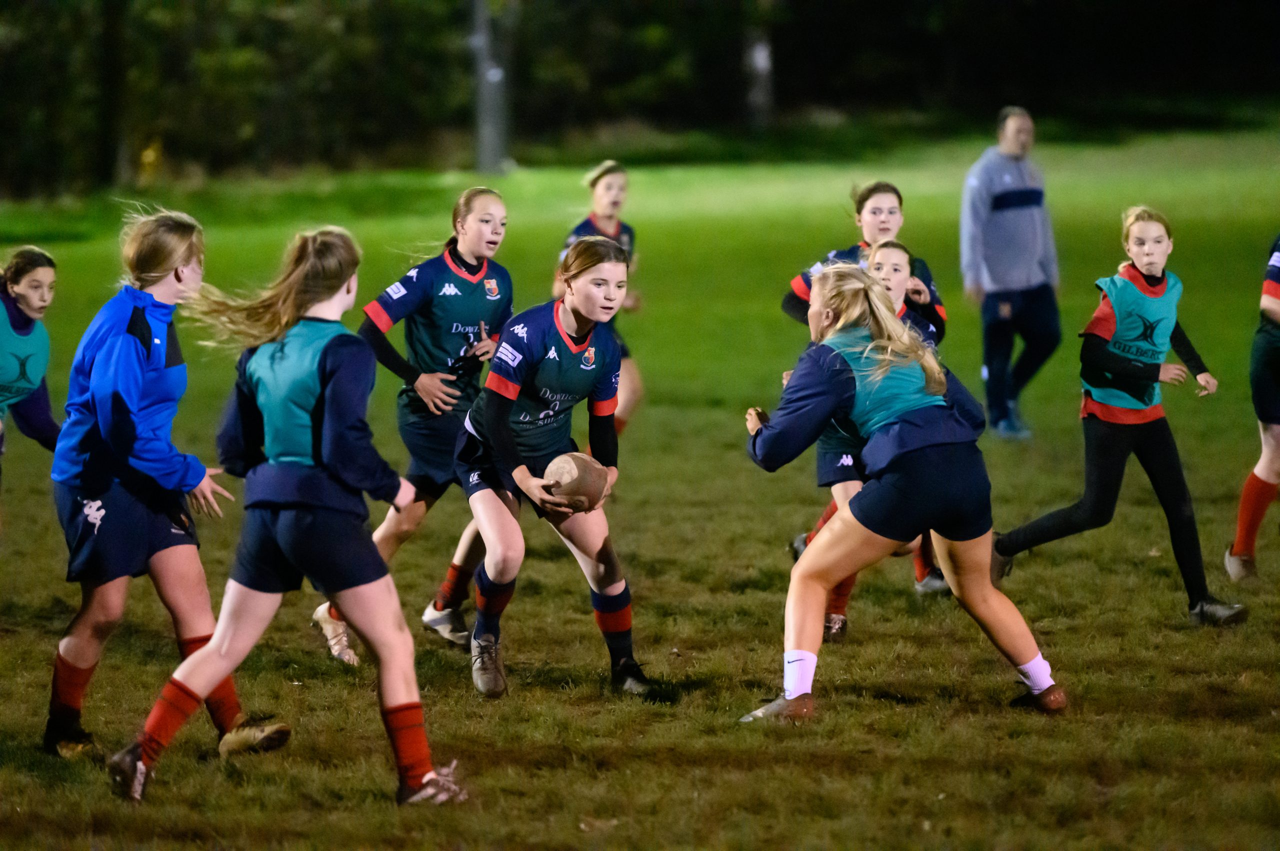 Teenage girls playing rugby