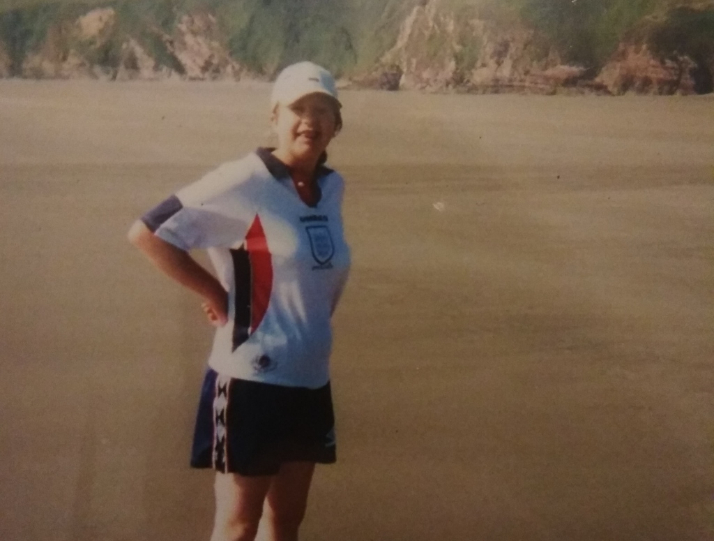 Gemma playing football on the beach