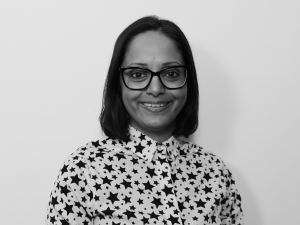 Varsha Patel, a south Asian woman with glasses, smiling