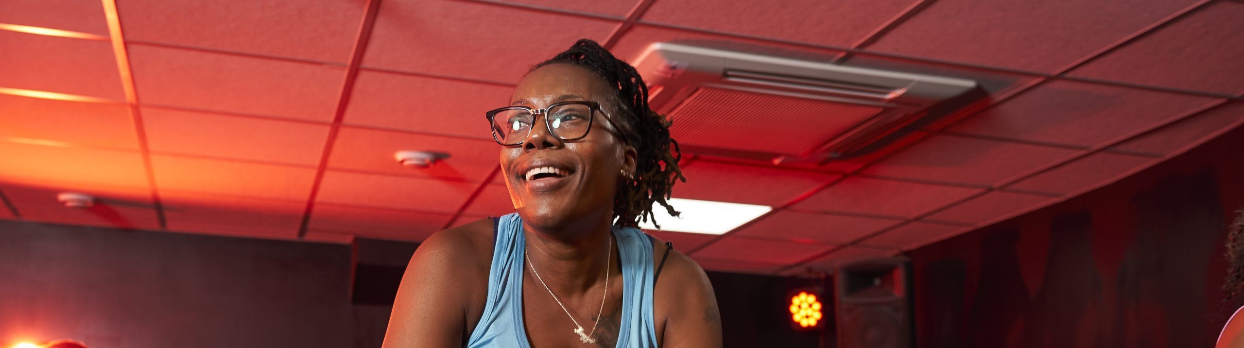 A black woman with braids in a spin cycling class