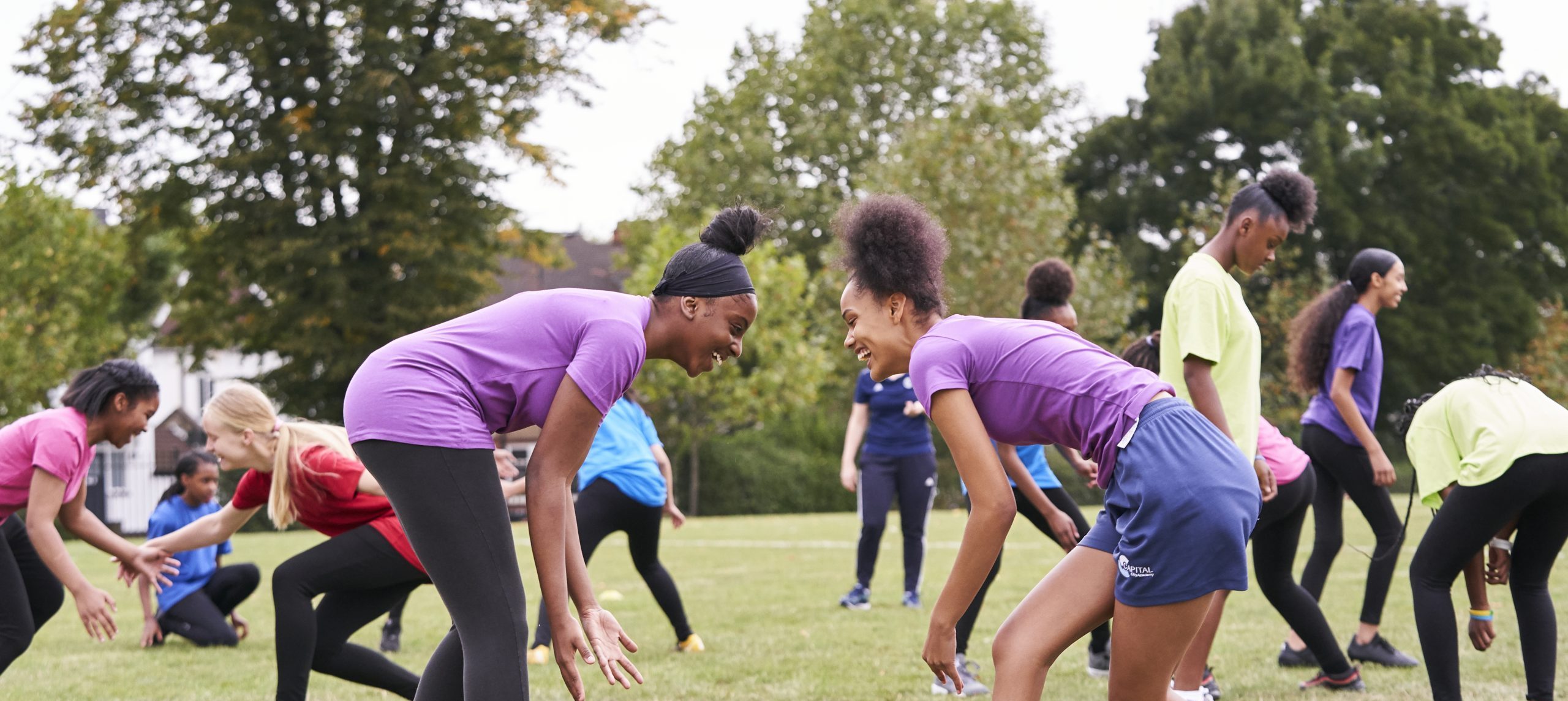 Two black girls playing rugby at school