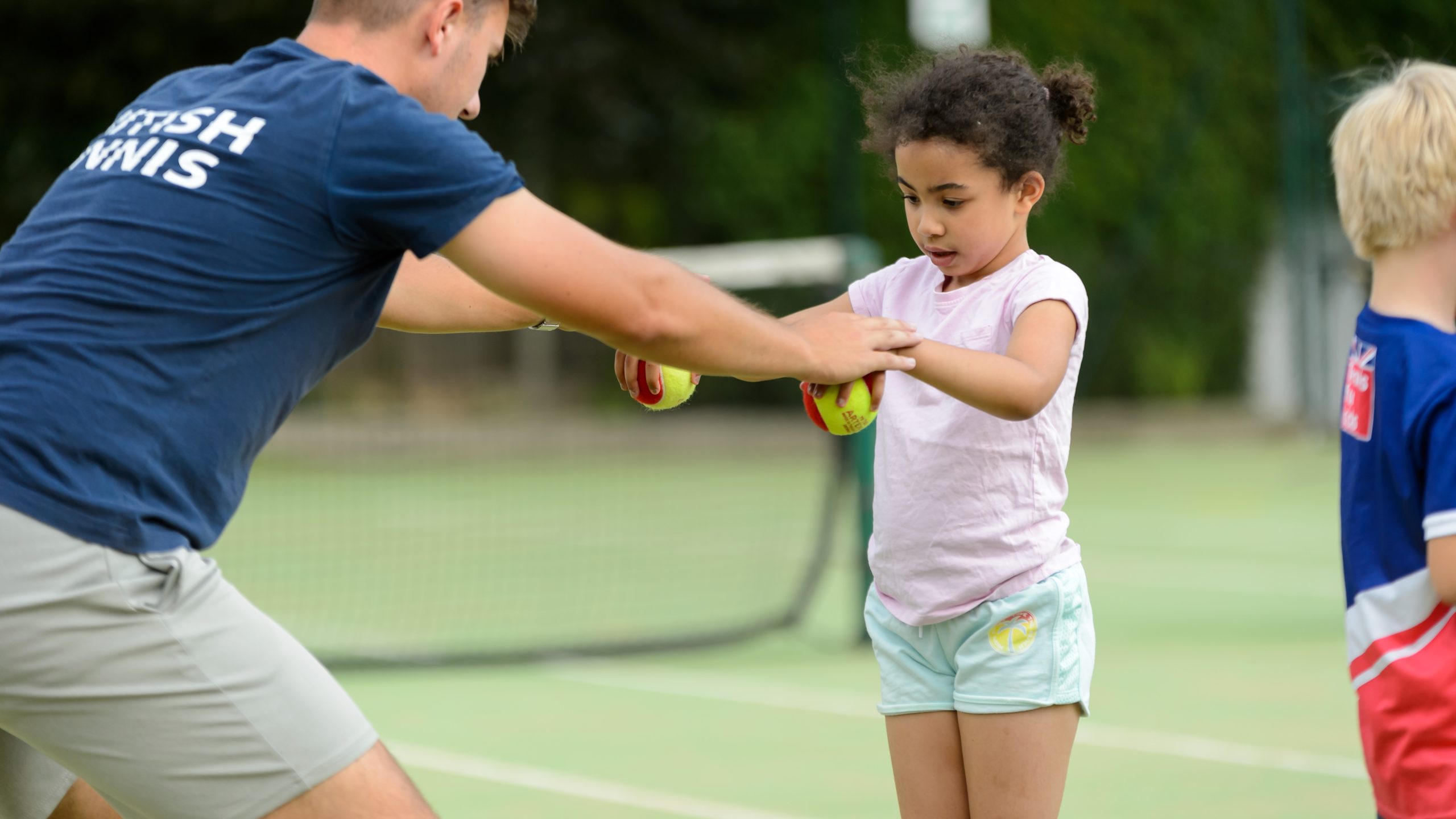 Tennis coach and young girl