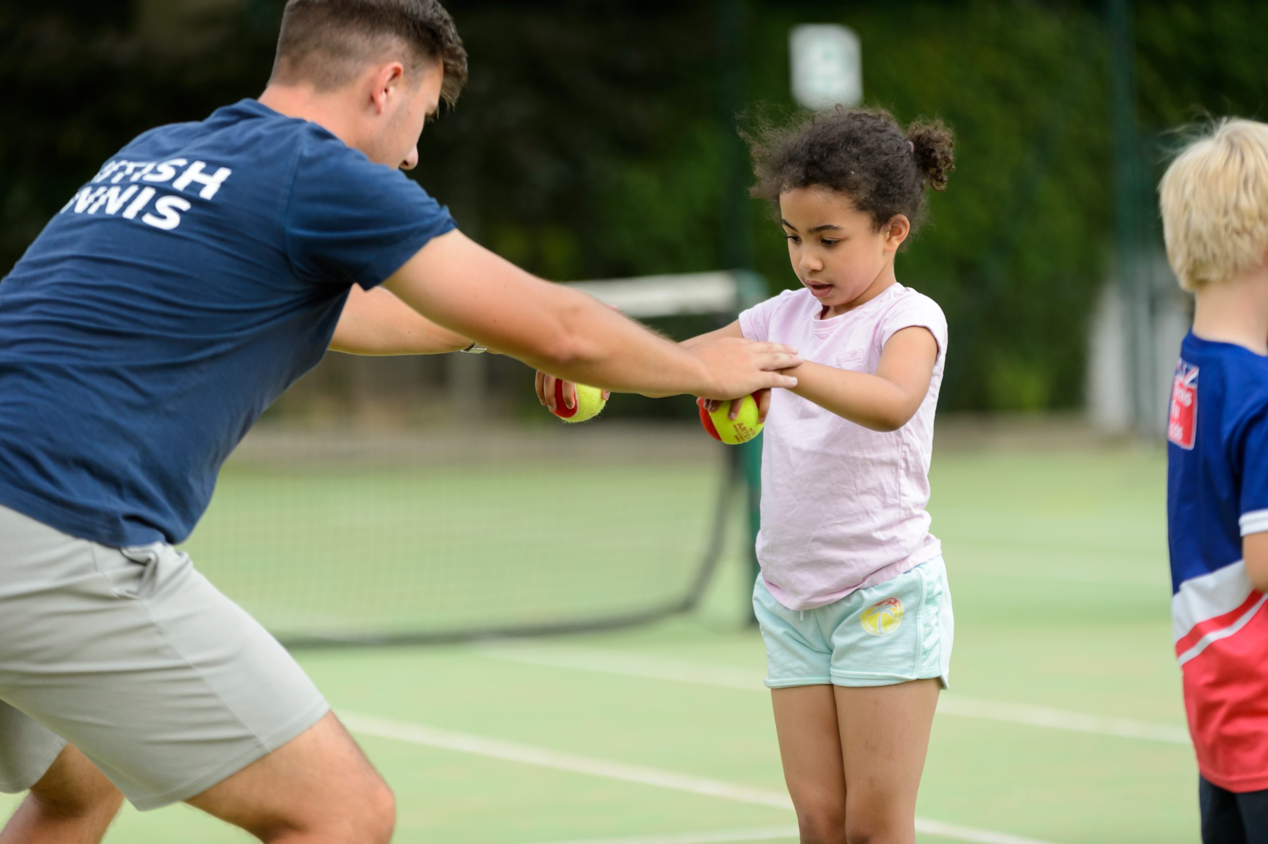 Tennis coach and young girl