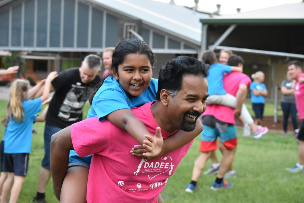 A south asian daughter and dad having a piggy back