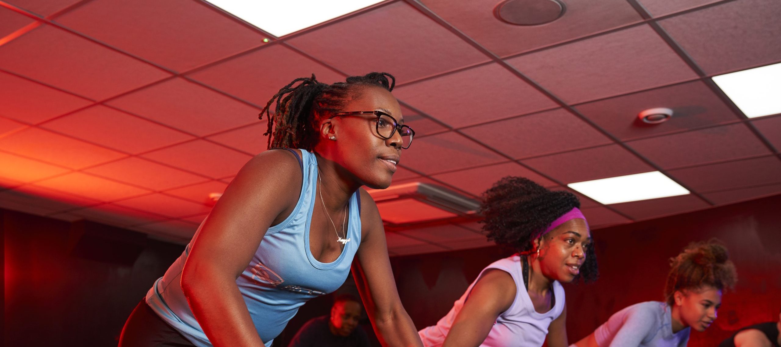 Three black women in a spin cycling class