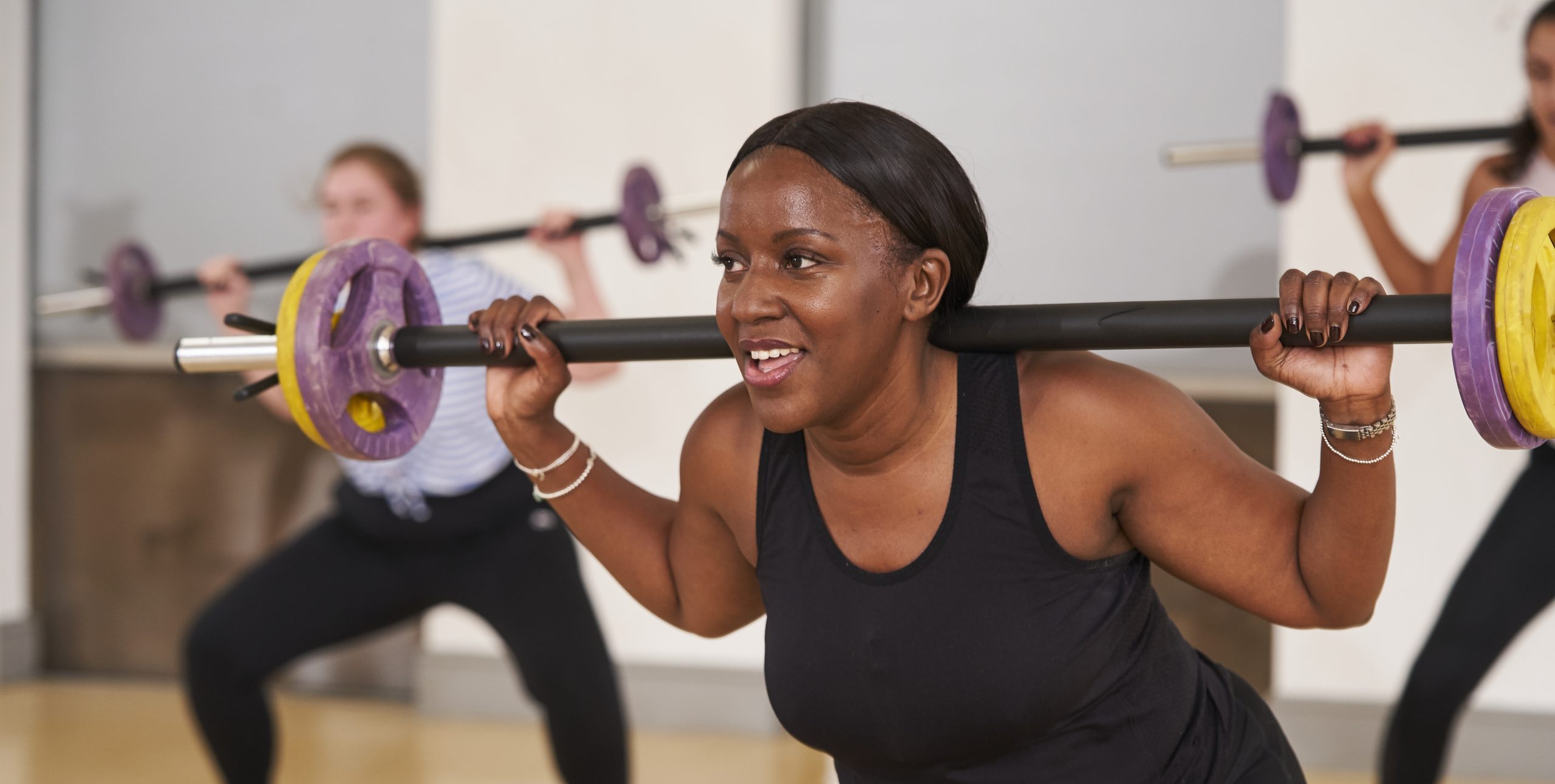 Black woman aged 34-45 lifting weights