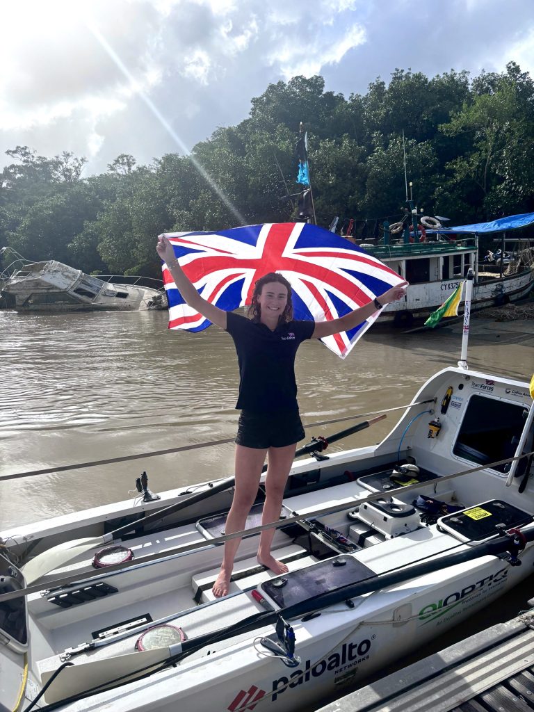 Zara Lachlan at the finish waving a Great Britain flag