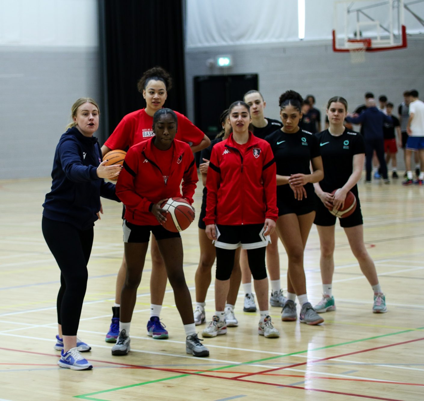 Female basketball coach teaching young women