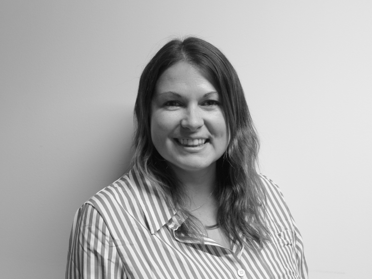 Claire, a woman aged 40-50 with shoulder length brown hair, smiling