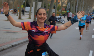 Julieta running and smiling with her arms raised